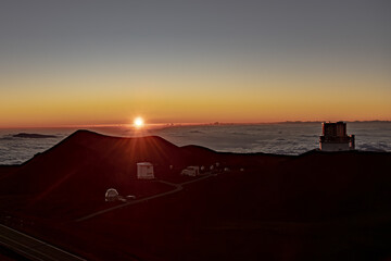 Fototapeta na wymiar Mauna Kea Volcano's Summit along the Scenic Drive Above the Clouds at Sunset with Observatory 