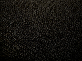 Background of knitted texture of black color fabric or knitwear closeup. Copy space