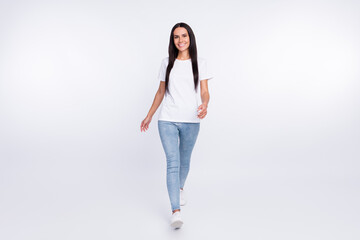 Full length body size photo of walking forward girl wearing casual outfit isolated on white color background