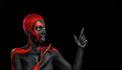 The Art Face. Black and yellow body paint on african woman. Abstract creative portrait. Copy space for your text - 738049635