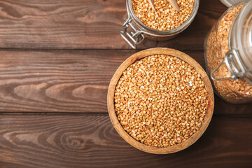 Green buckwheat in a bowl on a wooden kitchen table.Superfood.Raw buckwheat porridge.Healthy vegan food concept, eco products, diet. Copy space.Organic food.weight loss and proper nutrition.