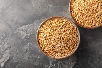 Green buckwheat in a bowl on a wooden kitchen table.Superfood.Raw buckwheat porridge.Healthy vegan food concept, eco products, diet. Copy space.Organic food.weight loss and proper nutrition.