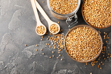 Green buckwheat in a bowl on a wooden kitchen table.Superfood.Raw buckwheat porridge.Healthy vegan food concept, eco products, diet. Copy space.Organic food.weight loss and proper nutrition.