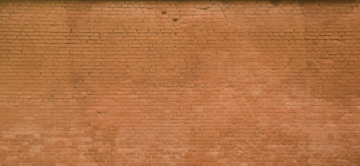 The texture of the brick wall of many rows of bricks painted in brown color