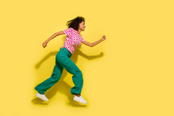 Fototapeta na wymiar Full size profile photo of energetic carefree girl jump run fast empty space isolated on yellow color background