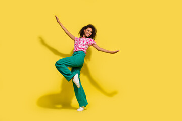 Fototapeta na wymiar Full size photo of carefree lovely girl enjoy dancing empty space ad isolated on yellow color background
