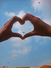 Portrait Heart of hands in sky.