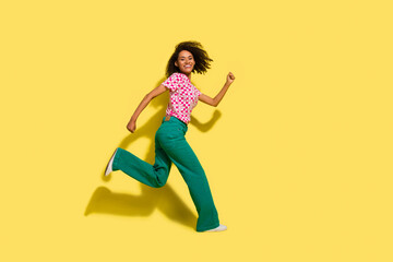Fototapeta na wymiar Full body profile photo of nice overjoyed active person running empty space isolated on yellow color background
