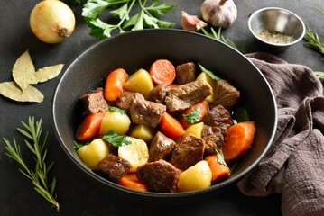 Beef stew with potatoes, carrots and greens