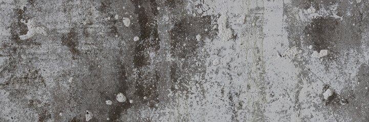 Texture of old concrete wall. Rough gray concrete surface with white spots. Wide panoramic...