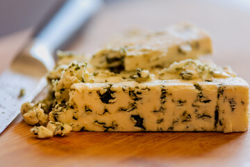 delicious blue cheese close-up on wooden board 