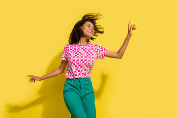 Photo of positive lovely girl have good mood enjoy dancing isolated on bright yellow color...