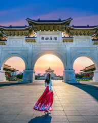 Asian woman in chinese dress traditional walking in Archway of Chiang Kai Shek Memorial Hall in Taipei, Taiwan. 