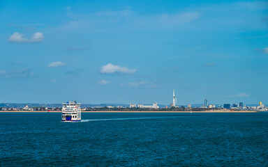 A view with a sea ferry heading to the Portsmouth harbour in summer