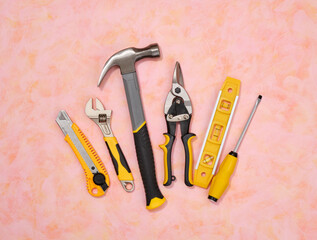 DIY tools set. Hammer, metal shears, yellow utility knife, building level, adjustable spanner and...