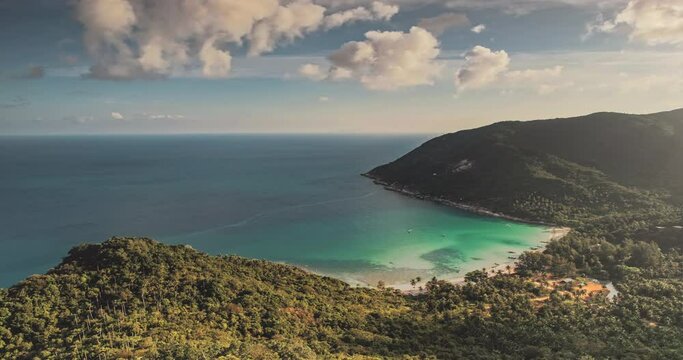 Aerial view of mountains island lagoon. Ocean timelapse cloud sunset. Coast paradise sand beach with boat. Tropical green forest. Wild virgin nature. Blue sky cinematic scenery. Koh Phangan. Thailand