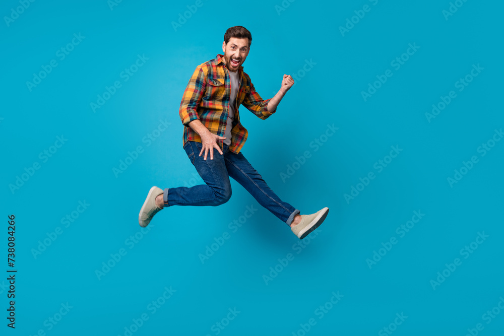 Sticker Full body photo of attractive young man running play guitar jumping dressed stylish checkered clothes isolated on blue color background