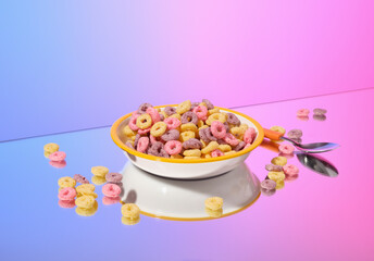 Dry colored breakfast cereal in a bowl and spoon. Proper nutrition and healthy lifestyle.