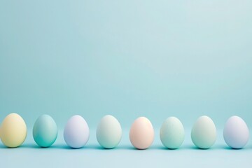 a row of pastel colored easter eggs on a blue background