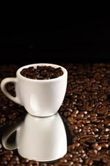espresso cup full of coffee beans with seeds around