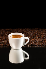 espresso coffee in white cup and coffee beans background