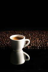 Obraz na płótnie Canvas espresso coffee in white cup and coffee beans background