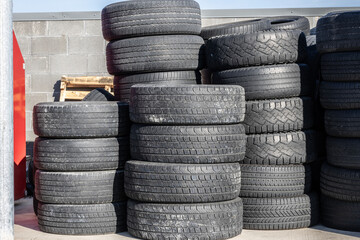 Old, discarded tires, tyres, waiting for the scrap heap or to be recycled.