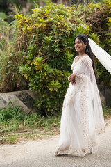 south Asian, wedding photography, woman, Christian wedding, outdoor, beautiful natural background, walking with wedding dress