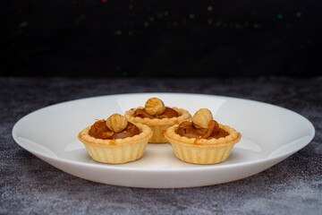 Mini tart. Fresh tartlets with caramel hazelnuts.