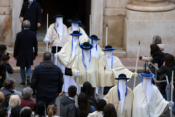 Holy Week Rites in Taranto. Brothers in procession. Procession of the Mysteries. Puglia, Italy - obrazy, fototapety, plakaty
