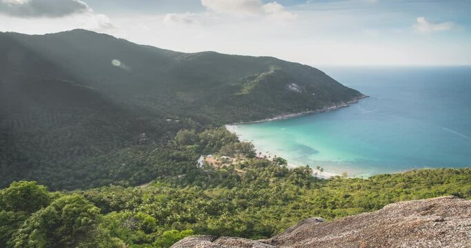 Aerial mountains island lagoon. Ocean view timelapse cloud sunset. Coast paradise sand beach with boat and tropical green forest. Wild virgin nature. Blue sky cinematic scenery. Koh Phangan. Thailand