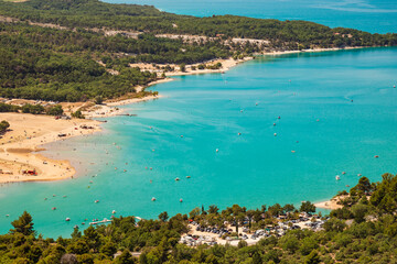 Lake of Sainte Croix du Verdon in the Verdon Natural Regional Park, France panoramic view with kayaks and boats.

