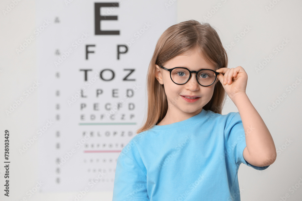 Sticker little girl with glasses against vision test chart