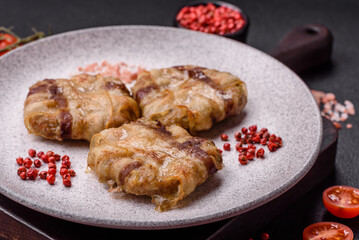 Round minced chicken or pork cutlet wrapped in bacon with salt, spices and herbs