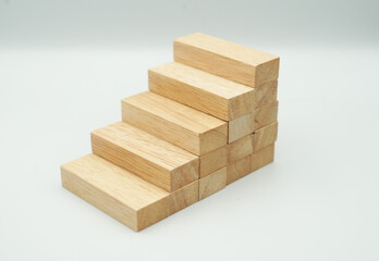 Stacking wooden blocks, concept of business growth success.