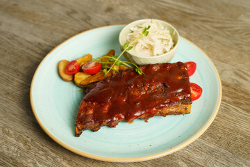 BBQ pork ribs with steak potatoes and cabbage salad