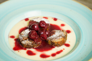 Poppy seeds bread pudding with cherry ragout and red wine