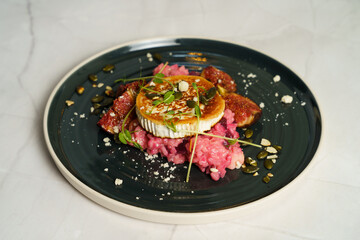 Risotto with beetroot, grilled goat cheese, fig and toasted pumpkin seeds
