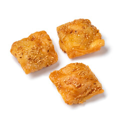 Deep fried, traditional Moroccan square shaped, Rghayef honey cookies isolated on white background close up