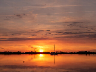 Anchored sailboats at sunset on Lake De Morra, Friesland, Netherlands