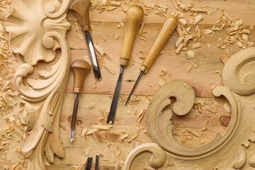 Wood carving tools with Wood shavings on the carpenter's workbench top view. Woodworking and...