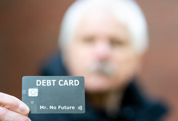 Old ma holds a debit card with the label 'debt card'.