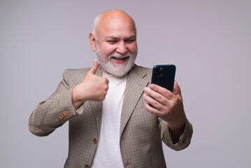 Senior man using smartphone, happy face. Mature man talk on mobile phone.