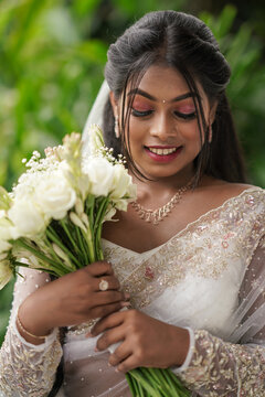 south Asian, wedding photography, woman, Christian wedding, outdoor, beautiful natural background ,multiple different poses with a wedding bouquet flower