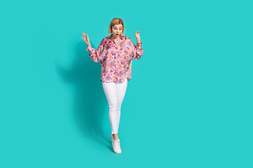 Full length photo of impressed girlish woman dressed print blouse stand on one leg look down at...