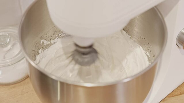 Close up video of robot mixer mixing dough for macaroons.
