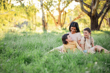Portrait of mother and children sitting together in Australian bush setting