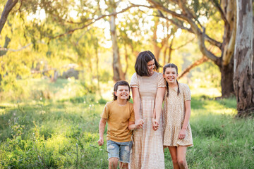 Portrait of mother and children walking together in Australian bush setting