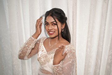 south Asian, wedding photography, woman, Christian wedding, white background, she holding her hair...