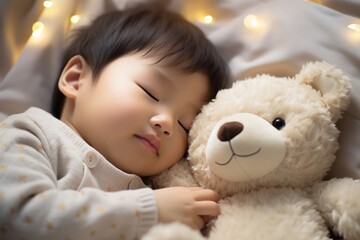 A young child sleeps soundly, cuddling with a plush teddy bear on a cozy bed.